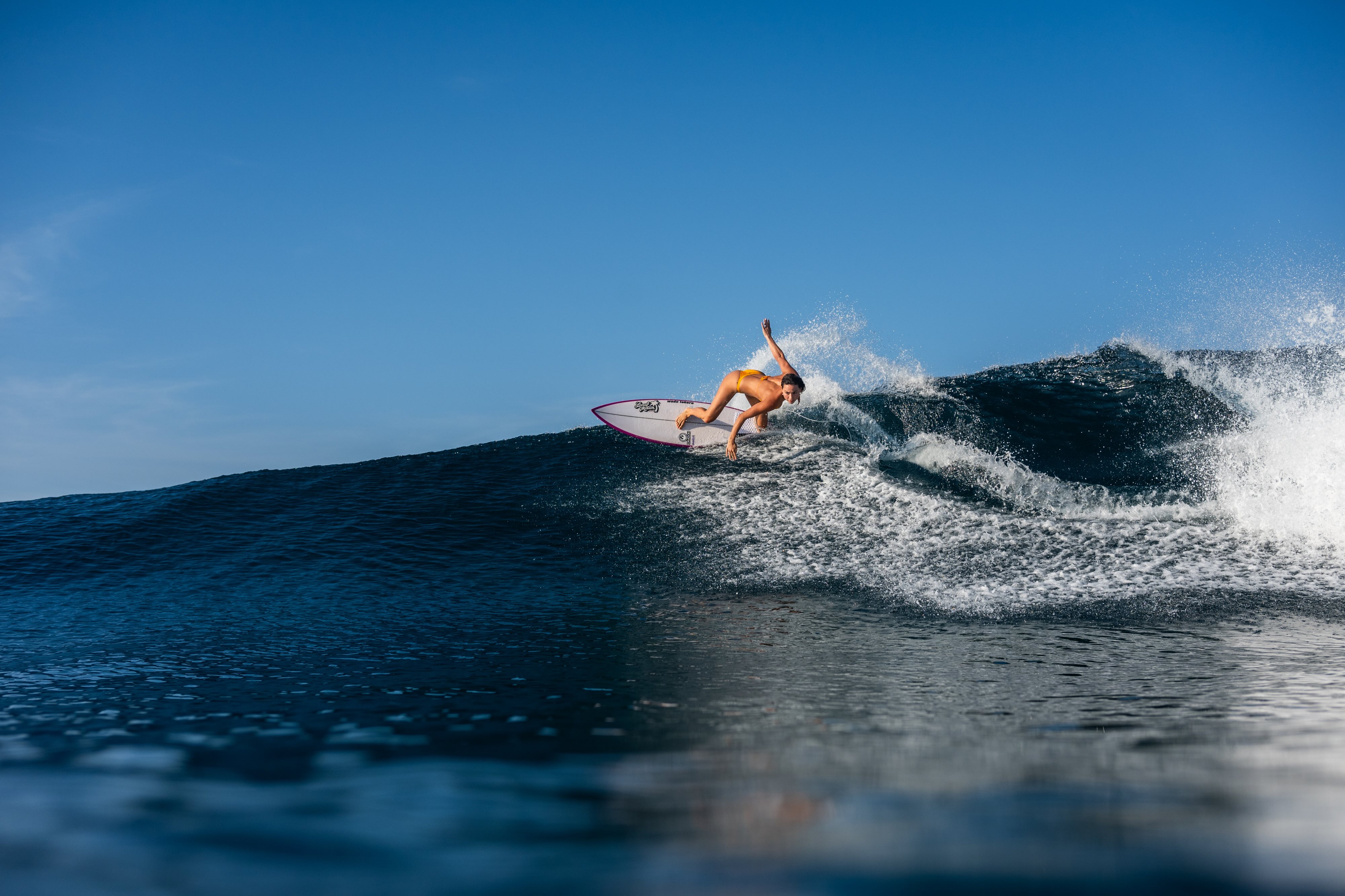 image of a person Surfing, image courtesy of NIHI Rote & Hospitality Academy